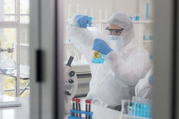 Health care researchers working in life science laboratory. Male research scientist and supervisor preparing and analyzing microscope slides in research lab. Invention of the coronavirus vaccine