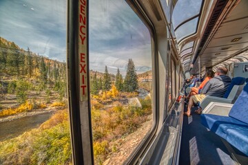 Amtrak Train crossing through the Colorado Rocky Mountains with peak Fall Colors in September