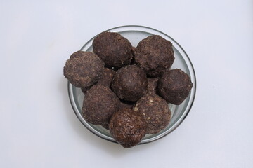 Nachni laddu or Ragi laddoo or balls made using finger millet on white background