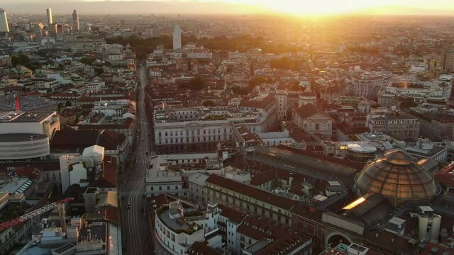 milan city aerial view drone flying over galleria vittorio emanuele at dawn sun rising over the skyline