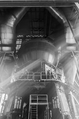 Engineers check and repair machine in a factory.