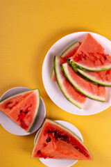 fresh and ripe watermelon on yellow background. minimalism style