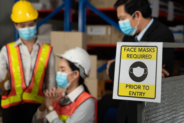 Caution sign in factory warning to industry labor worker to prevent Covid-19 Coronavirus spreading...