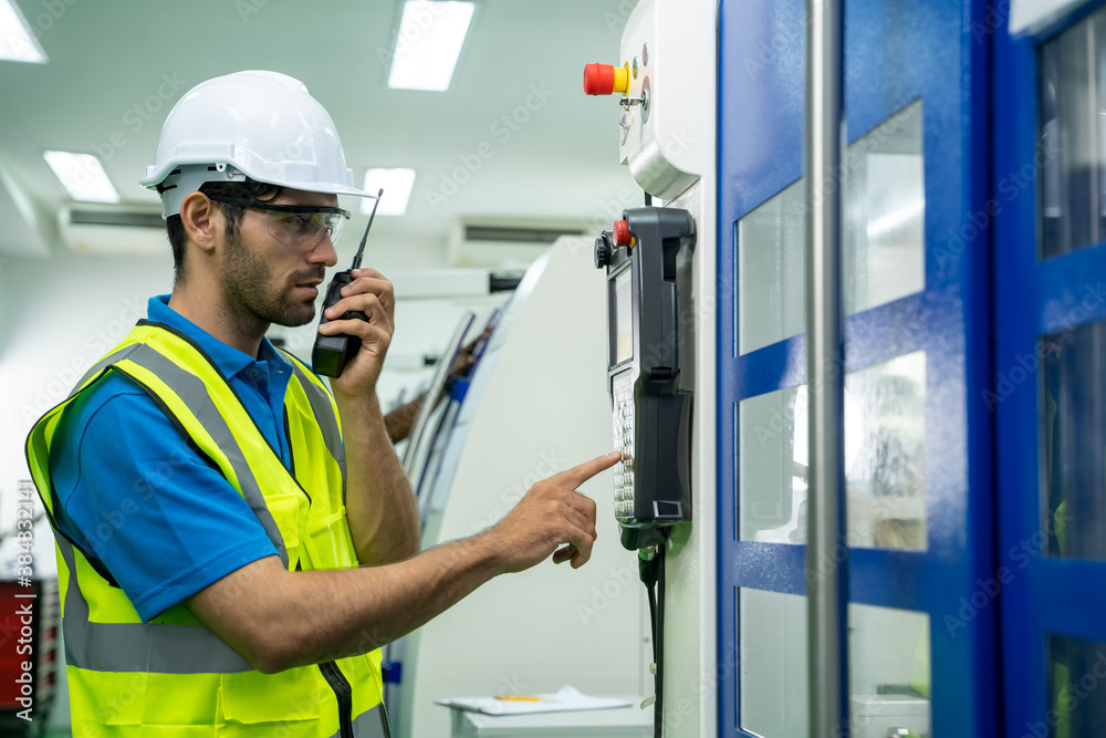 Poster factory engineers use radio to communicate in industrial factory.