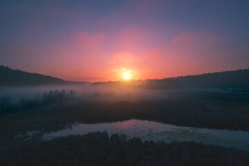 Obraz premium Magic sunrise over the lake. A serene lake in the early foggy morning. Nature landscape