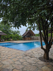 Mikumi, Tanzania - December 5, 2019:  refreshing pool in Africa on the lodge. Vertical
