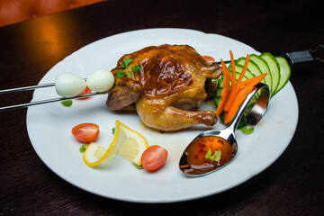Peking duck with sauce and vegetables on white plate