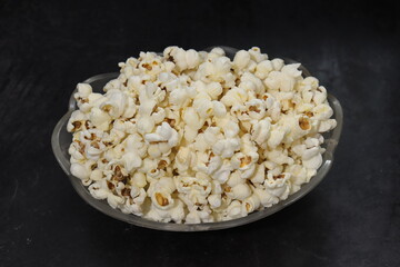 Heap of salted popcorn, isolated on white background.