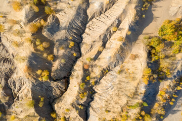 Top view of the mountainous folds of the terrain on an autumn day