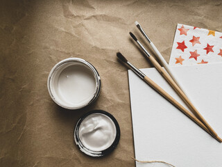 Acrylic paints, brushes and white canvas