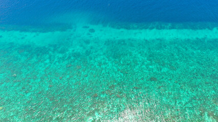 Naklejka na ściany i meble Sea water surface in lagoon with coral reef copy space for text. Top view transparent turquoise ocean water surface.