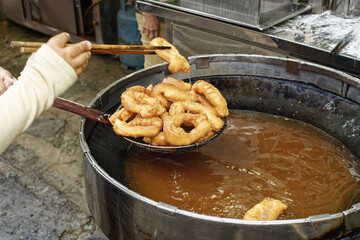 baking Chinese donuts in the central market in George Town, Penang, Malaysia.