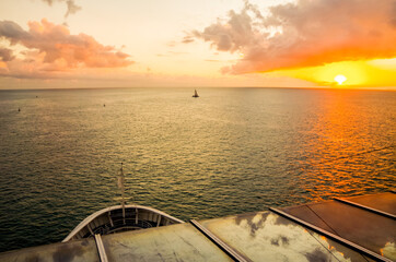 Silhouette of people at railing on luxury cruiseship or cruise ship liner watching sunset, sunrise...