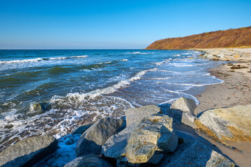 Stones protecting sand on beach near Kloster on island Hiddensee, Germany in Autumn or WInter.