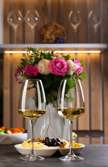 Two glasses of white wine are on the table.