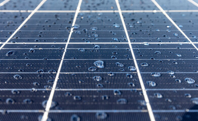 Solar panels on a construction site with raindrops on them