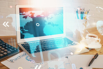 Double exposure of desktop with computer and world map hologram. International data network concept.