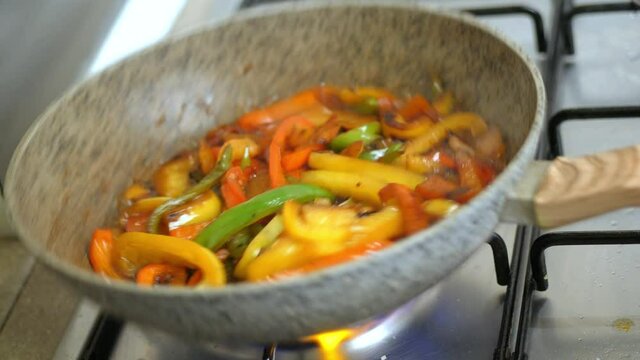 coocking fresh pepper  in the pot on fire