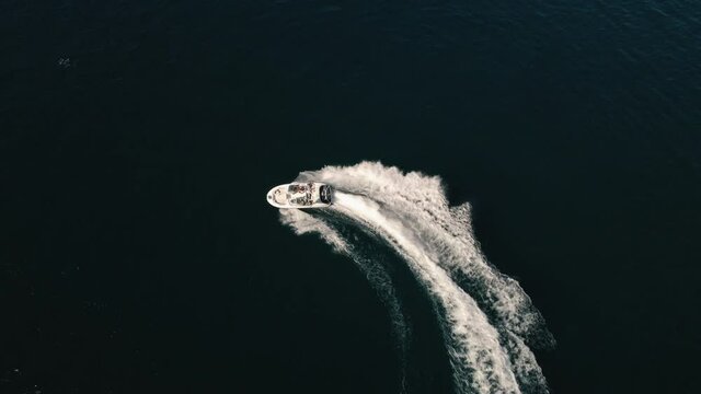 Drone Topview of Speedboat Circle Turns with People Enjoying Summer Recreation