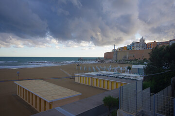 Termoli - Molise: The beach of the north coast and in the background the ancient village with the characteristic colored houses on a windy autumn day.