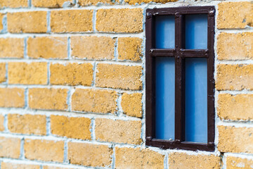 background from a miniature houses in a city park, yellow brick wall and windows