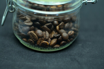 coffee beans in a glass jar with a closing lid