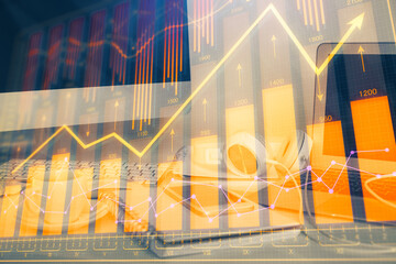 Financial graph colorful drawing and table with computer on background. Multi exposure. Concept of international markets.