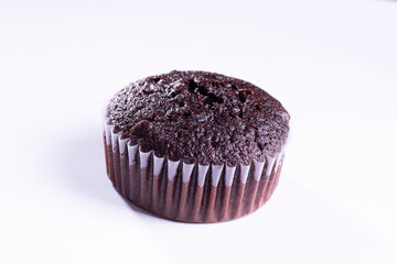 plain dark chocolate cupcakes in paper cups on white background - side View
