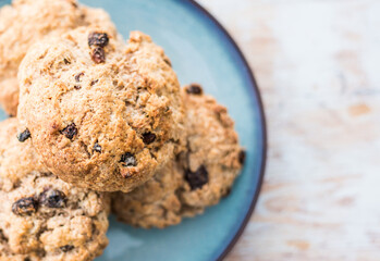 Fruit scones - freshly baked raisins and cinnamon scones on vintage plate