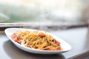 Quick dinner idea - takes 15 minutes - Italian spaghetti pasta with herbs, tomatoes and black pepper served on white plate