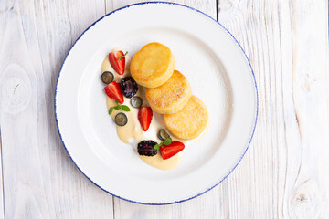 Cheesecakes traditional Russian food served with fresh berries