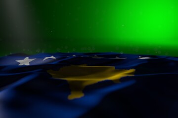 beautiful any occasion flag 3d illustration. - dark picture of Kosovo flag lay on green background with selective focus and free space for your text