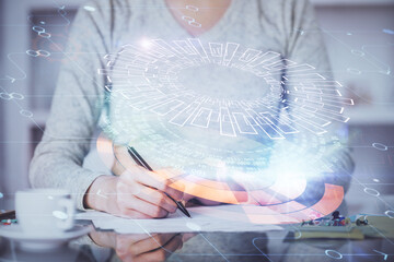 Double exposure of writing hand on background with data solution technology hologram. Ai concept.