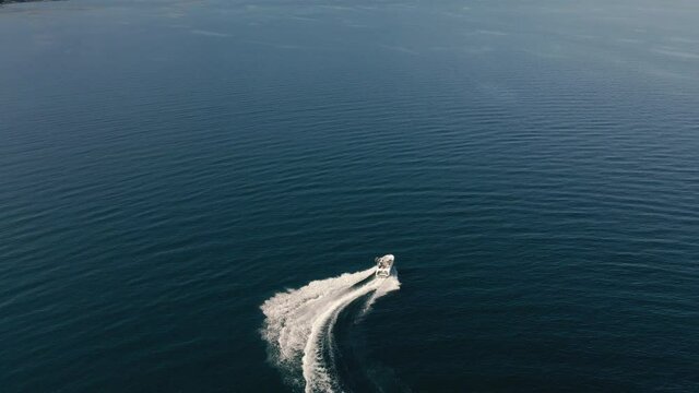 Drone View of Speedboat Making Quick Turns on Vibrant Blue Water