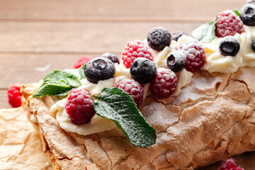 Closeup on meringue roll with berries 