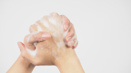 Fototapeta na wymiar Hands washing gesture with foaming hand soap on white background.
