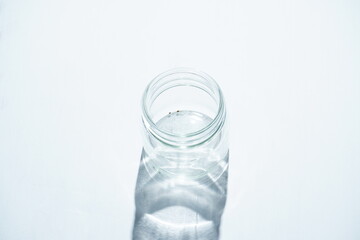 Transparent glass bottle on white background