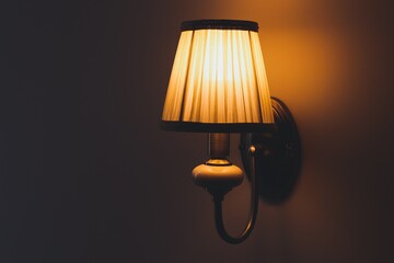 Luxurious lampshade with orange light on the wall