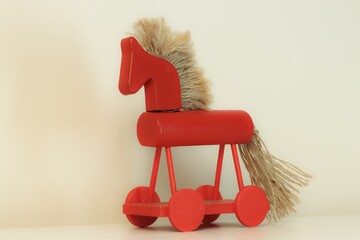 Red wooden horse with hair made of string