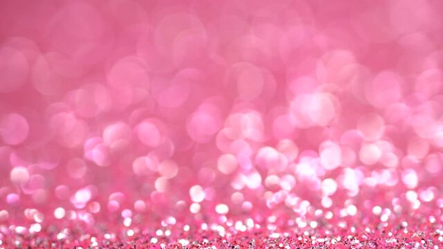 Pink glitter festive defocused lights background. Brilliant background for Christmas and new year holiday. A beautiful magic bokeh