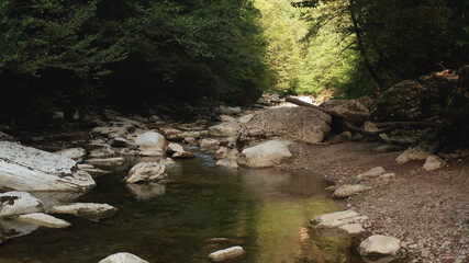 Naklejka na ściany i meble Mountain river and rocks. mountain river among large stones