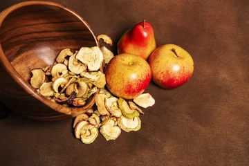 Foto op Canvas Dried apples and pears on a brown background © Fyle