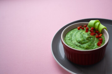 Creamy texture of green in a bowl with green vegetables spinach, broccoli and peas