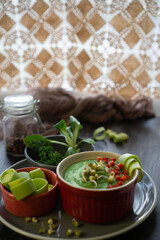 Healthy food with fresh green vegetables in a consistency of spinach and broccoli strips