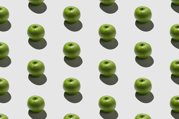 Green apple pattern on a white background. Hard shadows.