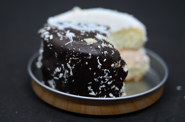 A bitten-off cake on a metal stand .