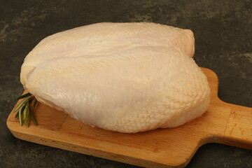Raw whole chicken breast with skin