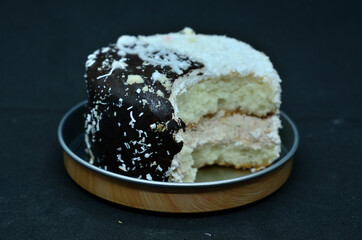 A bitten-off cake on a metal stand .