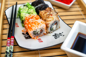 Several sushi on a white plate standing on a white background
