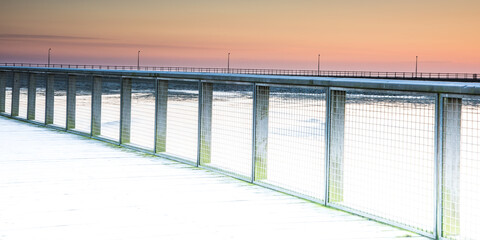 Wooden pier and colourful sunset sky in Amble, Northumberland